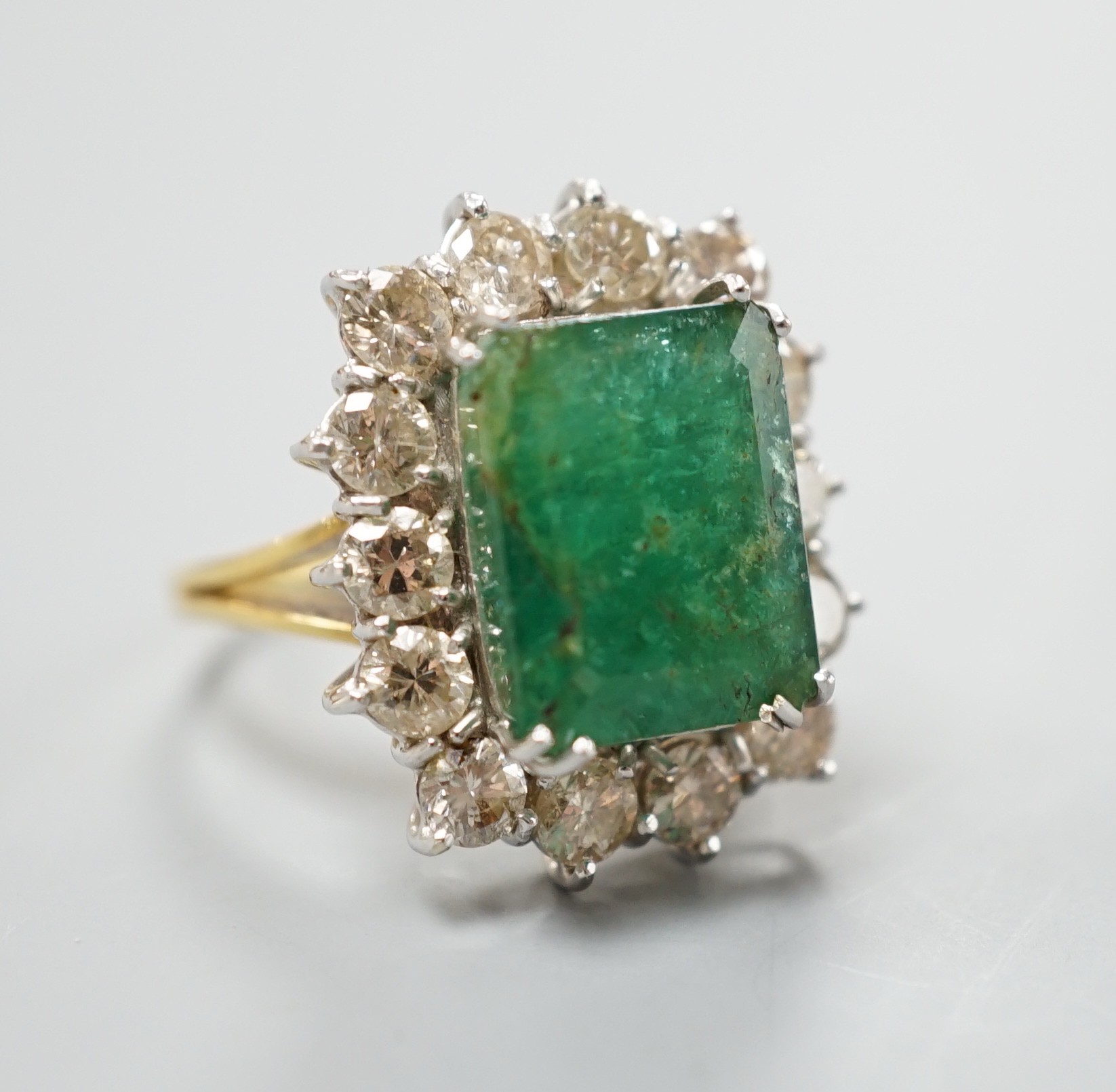 A yellow metal, emerald and diamond set rectangular cluster ring (shank cut), size M, gross weight 7.9 grams